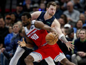 Sacramento Kings forward Harrison Barnes (40) battles Dallas Mavericks guard Luka Doncic for space during the first half of an NBA basketball game, Wednesday, Feb. 12, 2020, in Dallas. (AP Photo/Brandon Wade)