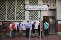 People wearing face masks queue for the coronavirus test outside a testing center in Hong Kong, Tuesday, Sept. 1, 2020. Hong Kong began a voluntary mass-testing program for coronavirus Tuesday as part of a strategy to break the chain of transmission in the city's third outbreak of the disease. The virus-testing program has become a flash point of political debate in Hong Kong, with many distrustful over resources and staff being provided by the China's central government and fears that the residents’ DNA could be collected during the exercise. (AP Photo/Kin Cheung)