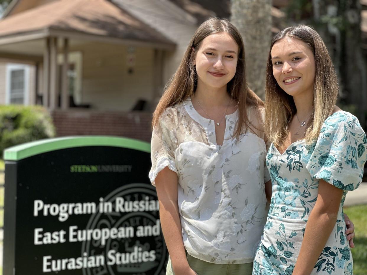 Yuliia Balan, left, and Yana Verbova pose for photos on the campus of Stetson University, where they will graduate with bachelor's degrees on Saturday. Both are from Ukraine and were provided scholarships from the school following Russia's invasion of Ukraine two years ago.