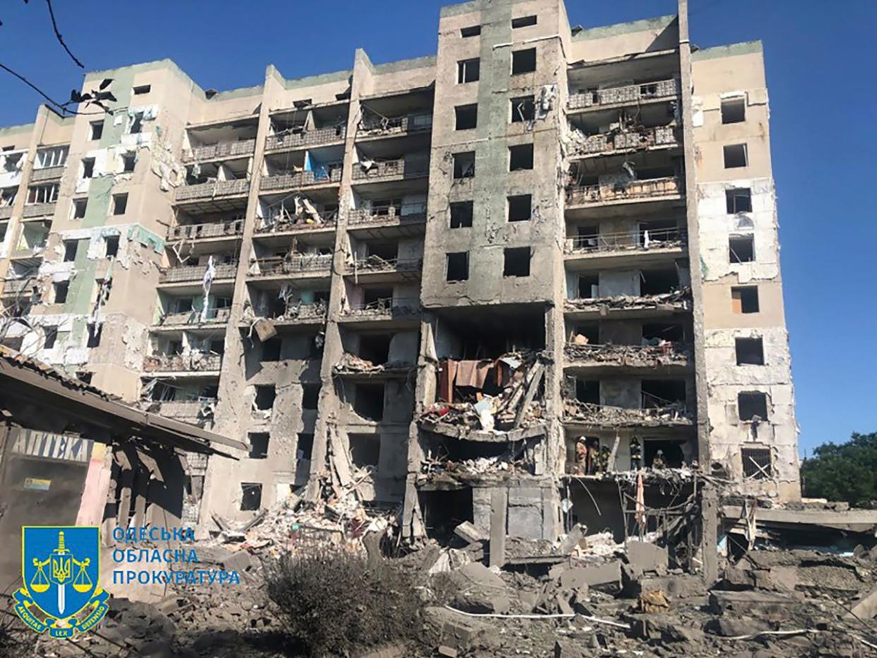 In this photo provided by the Odesa Regional Prosecutor's Office, a damaged residential building is seen in Odesa, Ukraine, early Friday, July 1, 2022, following Russian missile attacks. Ukrainian authorities said Russian missile attacks on residential buildings in the port city of Odesa have killed more than a dozen people. (Ukrainian Emergency Service via AP)