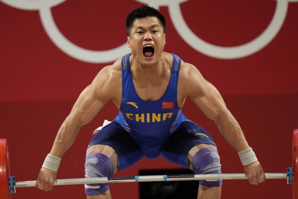 Lyu Xiaojun of China competes in the men's 81kg weightlifting event, at the 2020 Summer Olympics, Saturday, July 31, 2021, in Tokyo, Japan. (AP Photo/Luca Bruno)