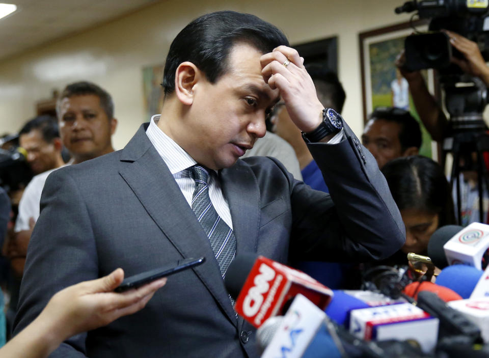 Philippine opposition Sen. Antonio Trillanes IV gestures as he talks to the media outside his office in the Philippine Senate after posting bail at a regional trial court following an arrest warrant issued Tuesday, Sept. 25, 2018 in suburban Pasay city, south of Manila, Philippines. Trillanes IV vowed to remain holed up in his office at the Senate until he is cleared of all the charges against him after President Rodrigo Duterte voided an amnesty given to the former rebel military officer. (AP Photo/Bullit Marquez)