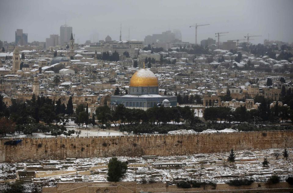 The snow capped Dome of the Rock in Jerusalem's Old City is seen from the Mount of Olives