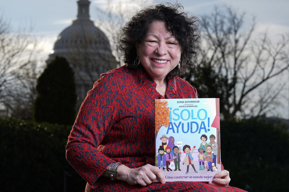 Supreme Court Associate Justice Sonia Sotomayor holds her new children's book "Just Help!" on Capitol Hill in Washington, Wednesday, Jan. 19, 2022. (AP Photo/Carolyn Kaster)