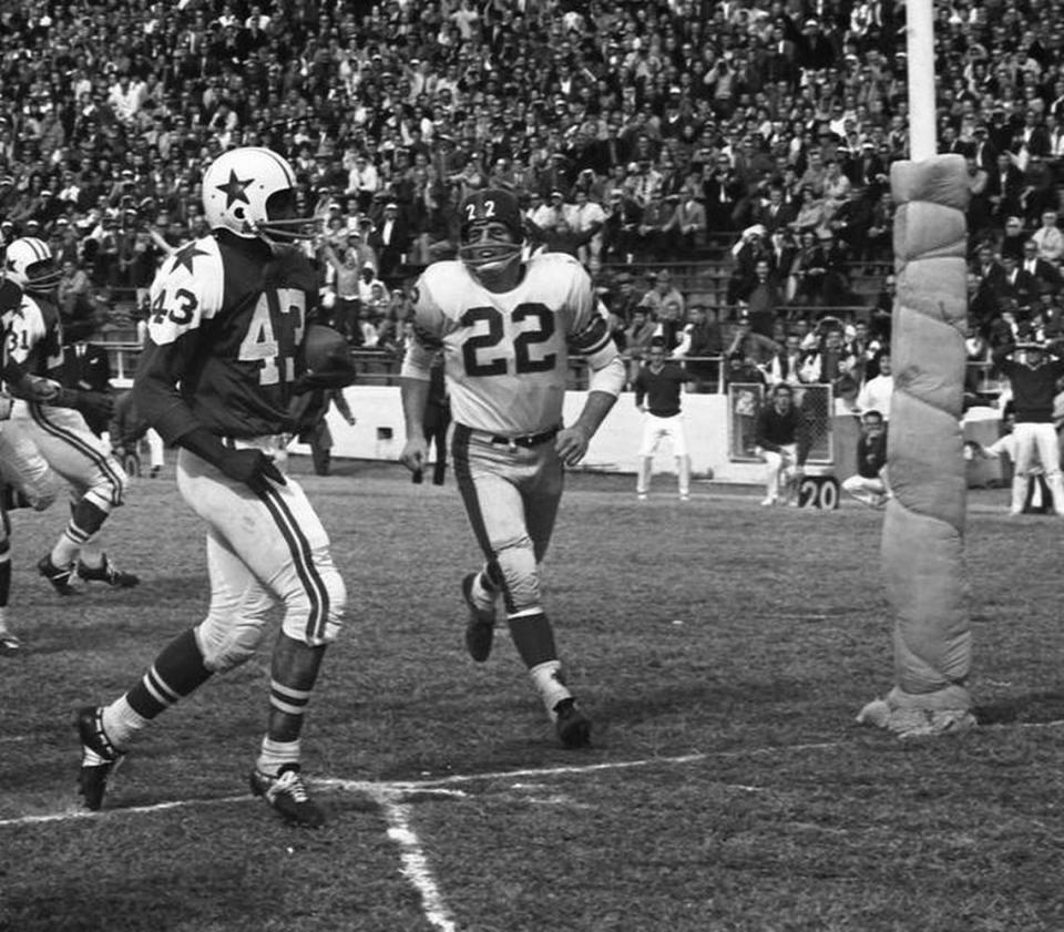 Dallas Cowboys running back Don Perkins is chased for a touchdown against the New York Giants Dick Lynch during an NFL game Dec. 1, 1963. The New York press that came to Dallas for the game weighed on a city where President Kennedy was assassinated.