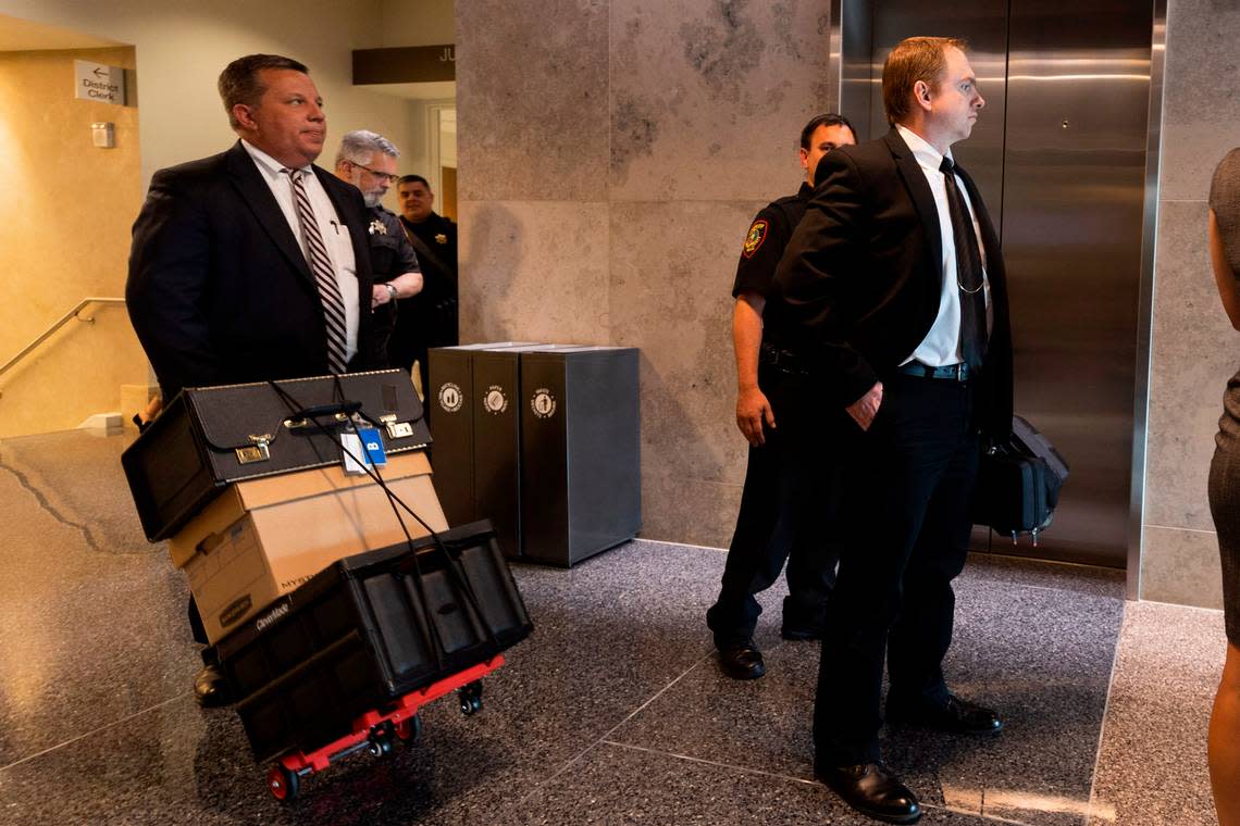 Defense attorney Miles Brissette, left, and Aaron Dean leave the courthouse after a hearing in May 2022 in Fort Worth.
