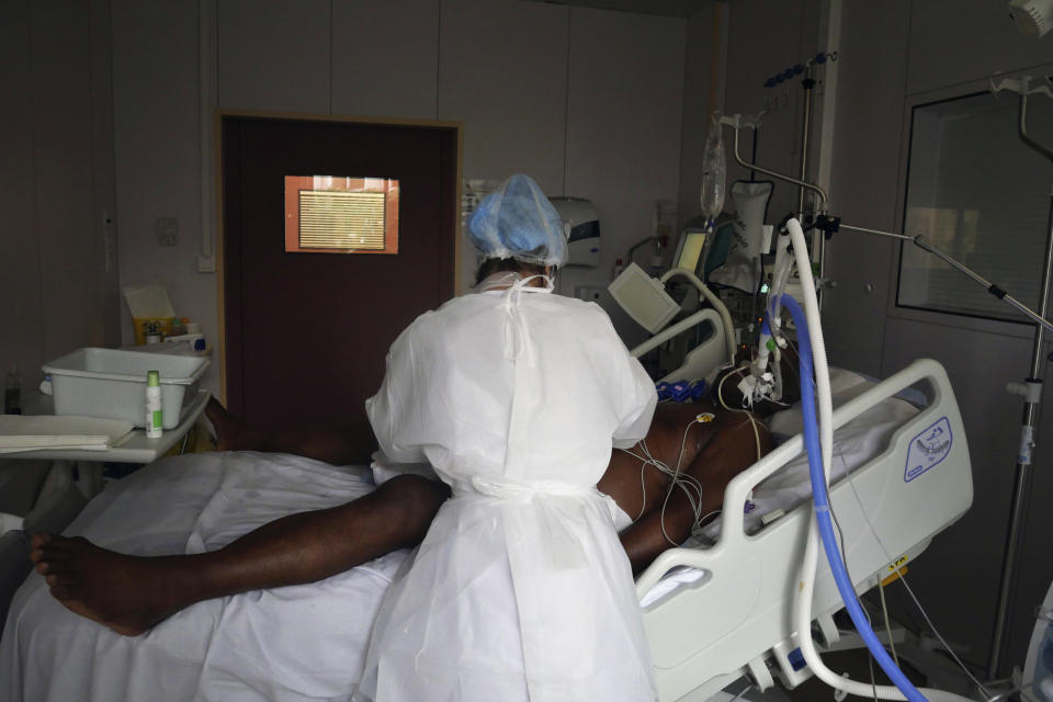 Nurse Stephanie Dias tends to a patient affected by COVID-19 virus in the ICU unit at the Ambroise Pare clinic in Neuilly-sur-Seine, near Paris, Friday, March 19, 2021. French Prime Minister Jean Castex announced new coronavirus restrictions as the number of COVID-19 patients in intensive care units spikes. (AP Photo/Thibault Camus)