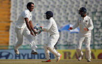 Cricket - India v England - Third Test cricket match - Punjab Cricket Association Stadium, Mohali, India - 26/11/16. India's Jayant Yadav (L) Parthiv Patel and Cheteshwar Pujara (R) celebrate the dismissal of England's Joe Root. REUTERS/Adnan Abidi