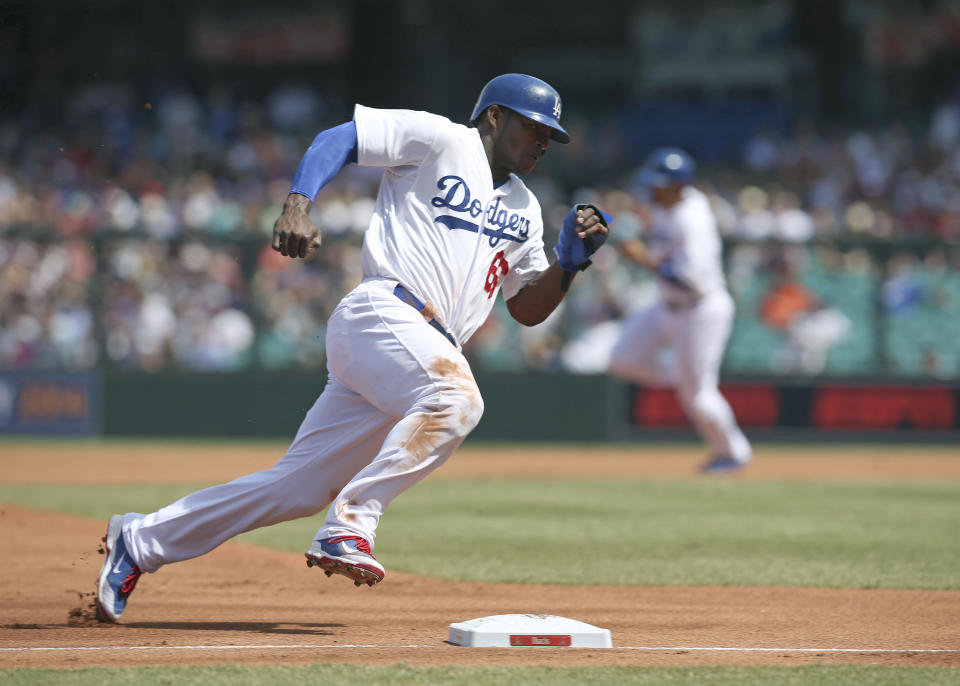The Los Angeles Dodgers' Yasiel Puig rounds third on his way to scoring during the second game of the two-game Major League Baseball opening series between the Los Angeles Dodgers and Arizona Diamondbacks at the Sydney Cricket Ground in Sydney, Sunday, March 23, 2014. (AP Photo/Rick Rycroft)
