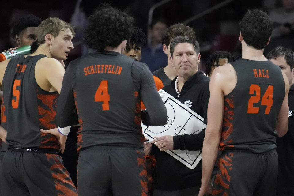 Clemson head coach Brad Brownell talks with his players during a time out during the first half of an NCAA college basketball game against Boston College, Tuesday, Jan. 31, 2023, in Boston. (AP Photo/Charles Krupa)