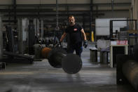 FILE - A man works at MAP, a factory operating in design, manufacture and installation of steel structures for civil and industrial use, in Corsico, near Milan, Italy, Thursday, May 12, 2022. It's not a summer heat wave that's making European leaders and businesses sweat. It's fear that Russia's manipulation of natural gas supplies will lead to an economic and political crisis next winter. Or, in the worst case, even sooner. (AP Photo/Antonio Calanni, File)