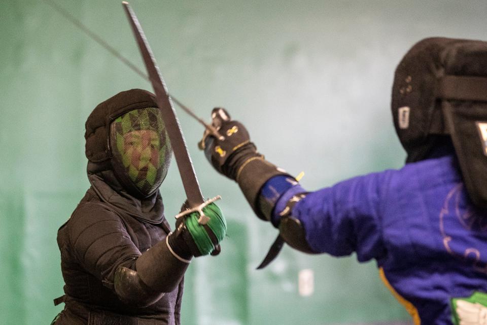 Kat Dunham, left, and Jacob Pigeon demonstrate a saber fight at Ars Gladii School of Chivalric Arts in Garden City on Saturday, April 29, 2023.