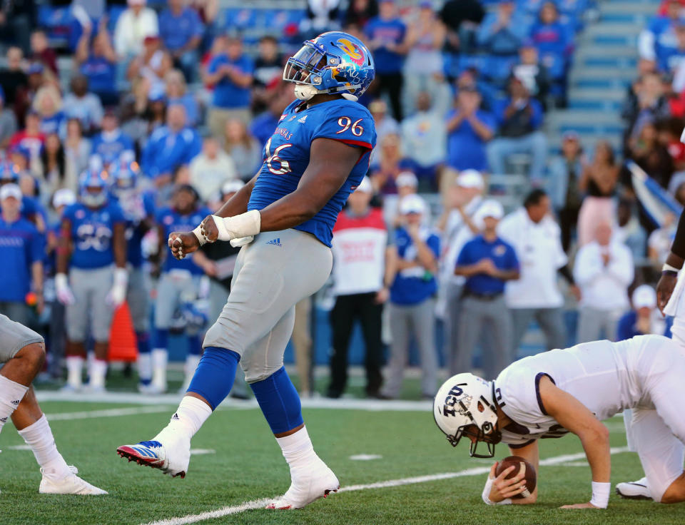 Oct 27, 2018; Lawrence, KS, USA; Kansas Jayhawks defensive tackle Daniel Wise (96) celebrates after a sack against TCU Horned Frogs quarterback Michael Collins (10) in the second half at Memorial Stadium. Mandatory Credit: Jay Biggerstaff-USA TODAY Sports