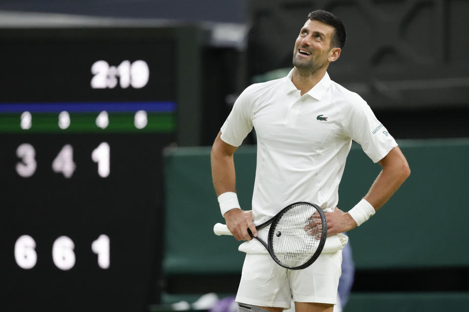 Novak Djokovic of Serbia reacts during his third round match against Alexei Popyrin of Australia at the Wimbledon tennis championships in London, Saturday, July 6, 2024. (AP Photo/Kirsty Wigglesworth)