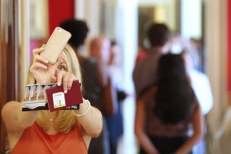 A visitor takes photos during a tour of the White House in Washington July 1, 2015. REUTERS/Jonathan Ernst