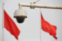 Red flags fly near a security camera on Beijing's Tiananmen Square, China May 19, 2017. REUTERS/Thomas Peter