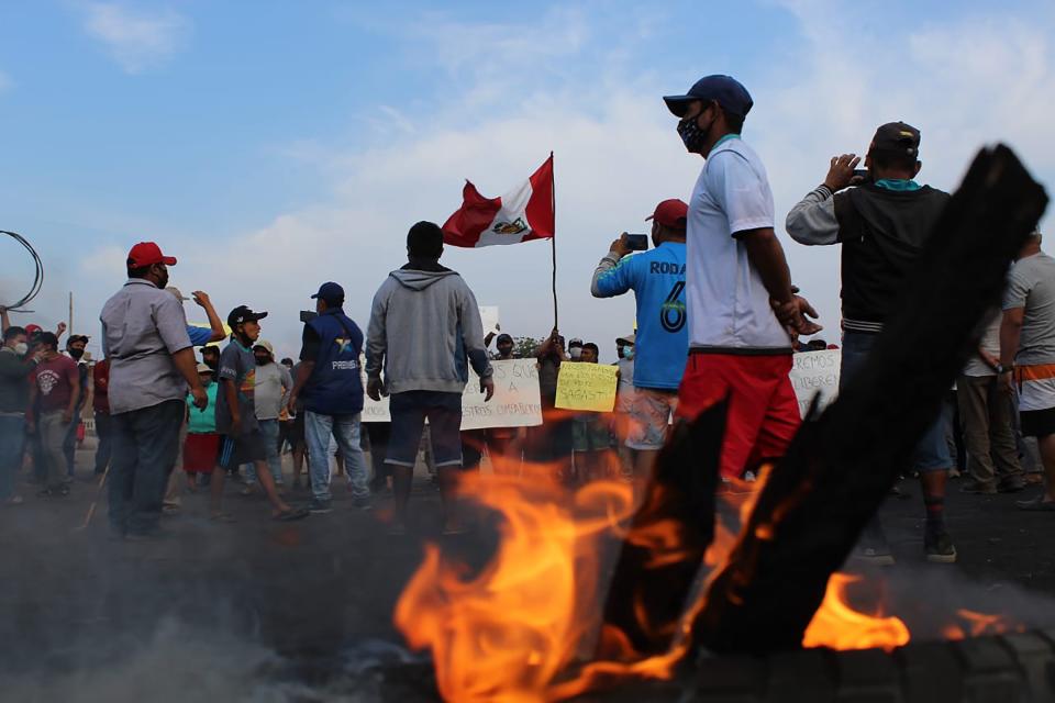 Trabajadores agrícolas bloquean un tramo de la Carretera Panamericana Sur en Viru, al norte de Lima, Perú, el miércoles 30 de diciembre de 2020. (AP Foto/Elmer Caceres)