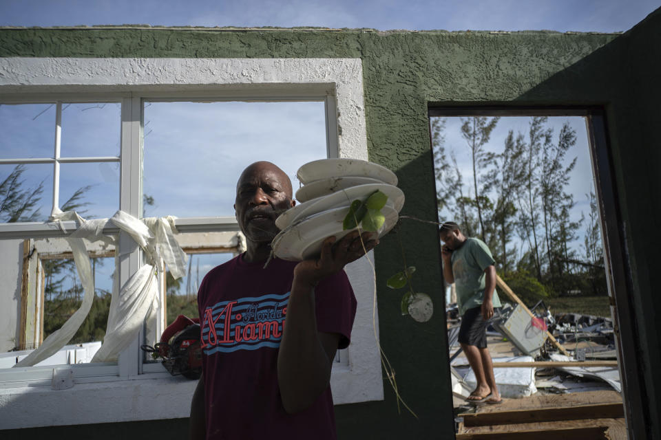 Mister Bolter recovers dishes from his son's home, destroyed by Hurricane Dorian in Pine Bay, near Freeport, Bahamas, Sept. 4, 2019. (Photo: Ramon Espinosa/AP)