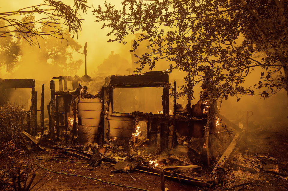 Flames consume an Oakmont neighborhood home as the Glass Fire burns in Santa Rosa, Calif., Monday, Sept. 28, 2020. (AP Photo/Noah Berger)