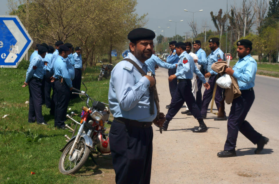 Police officers arrive at the residence of Pakistan's former president and military ruler Pervez Musharraf in Islamabad, Pakistan, Thursday, April 3, 2014. A bomb exploded Wednesday near a convoy carrying Musharraf, who is on trial for treason, but the former ruler was not harmed, a police official and his spokeswoman said Thursday. (AP Photo/B.K. Bangash)