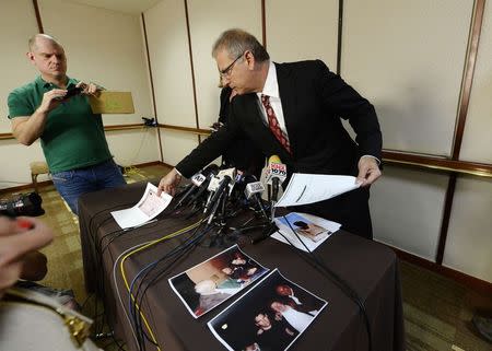 Jeff Herman (R), attorney for the anonymous victim in the allegation of child sexual abuse by Hollywood executives, displays photographs correspondences during a news conference in Beverly Hills, California May 5, 2014. REUTERS/Kevork Djansezian