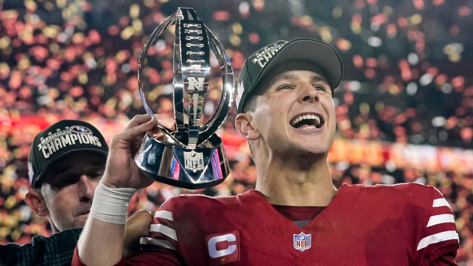 San Francisco 49ers quarterback Brock Purdy celebrates with the trophy after their win against the Detroit Lions in the NFC championship game in Santa Clara, Calif. - Godofredo A. Vasquez/AP