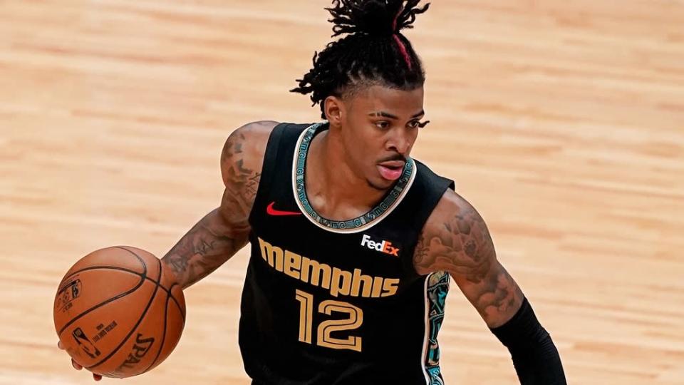 Apr 6, 2021; Miami, Florida, USA; Memphis Grizzlies guard Ja Morant (12) dribbles the ball against the Miami Heat during the second half at American Airlines Arena.
