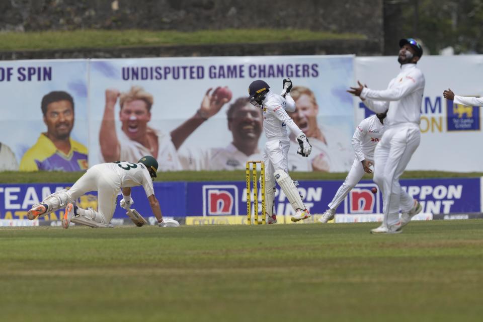 Sri Lanka's Niroshan Dickwella, second left, misses a possible stumping chance to dismiss Australia's Marnus Labuschagne, left, during the first day of the second cricket test match between Australia and Sri Lanka in Galle, Sri Lanka, Friday, July 8, 2022. (AP Photo/Eranga Jayawardena)