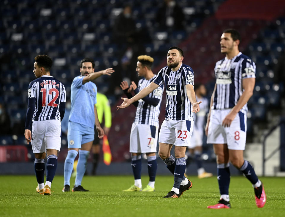 West Bromwich Albion players react after Manchester City's Joao Cancelo scoring his side's second goal during the English Premier League soccer match between West Bromwich Albion and Manchester City at the Hawthorns stadium in West Bromwich, England, Tuesday, Jan. 26, 2021. (Michael Regan/Pool via AP)