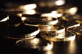 Golden coins on black background. Macro shot.