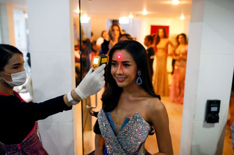 Aliya Sirisopha of Laos has her temperature checked before the final show of the Miss International Queen 2020 transgender beauty pageant in Pattaya