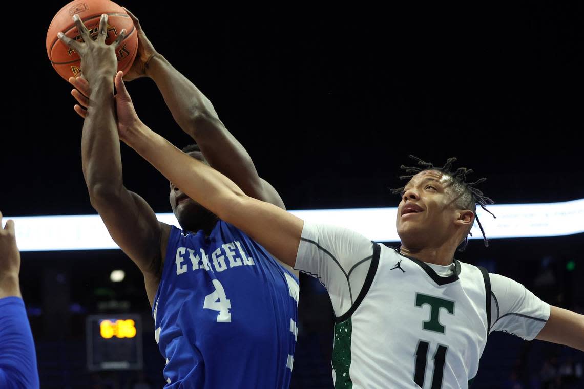 Trinity’s Jayden Johnson (11) and Evangel Christian’s Ben Mukadi (4) battle for a rebounds Friday night. Mukadi led Evangel with 11 boards.