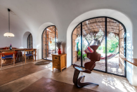 <p>The massive arched, glass doors let in plenty of natural light. (Airbnb) </p>