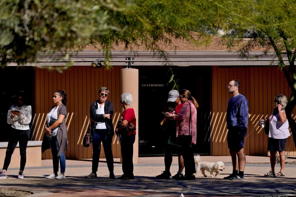 Voters wait in line outside a polling station on Nov. 8, 2022, in Tempe.