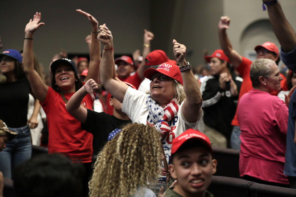 FILE - In this Jan. 3, 2020 file photo, supporters of President Donald Trump turn and yell towards the news media during a rally for evangelical supporters at the King Jesus International Ministry in Miami. Trump's bond with white evangelical voters has long sparked debate. But misunderstandings persist about his support from a Christian voting bloc that favored the GOP long before he took office. (AP Photo/Lynne Sladky, File)