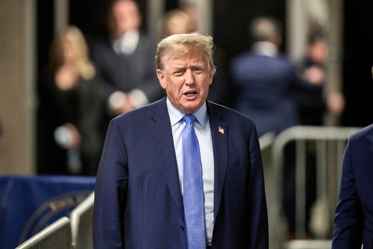 Former president Donald Trump speaks with the media at the end of the day’s proceedings at his trial at Manhattan Criminal Court on Friday 26 April 2024 (AP)