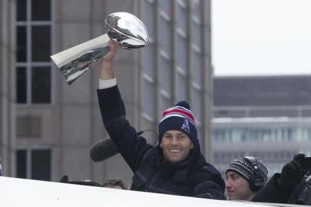 Tom Brady, the New England Patriots quarterback and Super Bowl MVP, holds the Super Bowl trophy during the New England Patriots Super Bowl XLIX victory parade in Boston, Massachusetts February 4, 2015. REUTERS/Katherine Taylor