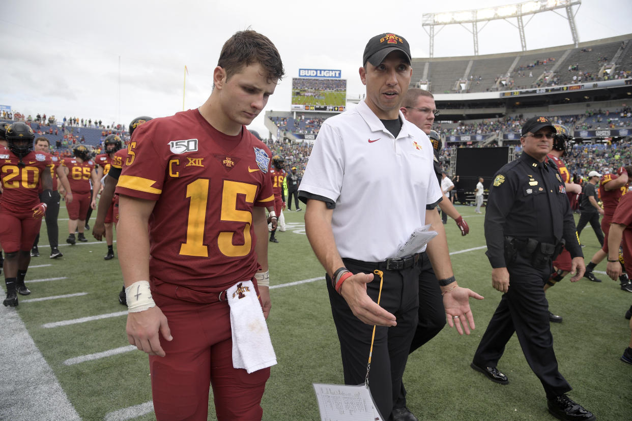 Iowa State coach Matt Campbell, center, walks off the field with QB Brock Purdy after a game against Notre Dame on Dec. 28, 2019. (AP)