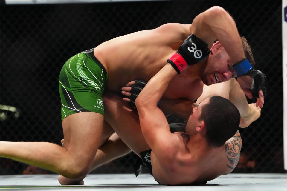 Jul 8, 2023; Las Vegas, Nevada, USA; Robert Whittaker (red gloves) fights Dricus Du Plessis (blue gloves) during UFC 290 at T-Mobile Arena. Mandatory Credit: Stephen R. Sylvanie-USA TODAY Sports