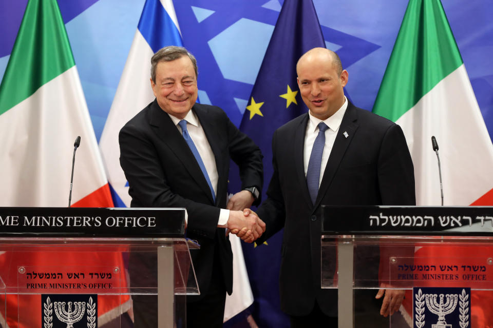 Italian Prime Minister Mario Draghi, left, shakes hands with Israeli Prime Minister Naftali Bennett during a press statement at the prime minster's office in Jerusalem, Israel, Tuesday, June 14, 2022. Draghi is on two-day official visit to Israel and the Palestinian authority. (Abir Sultan/Pool via AP)