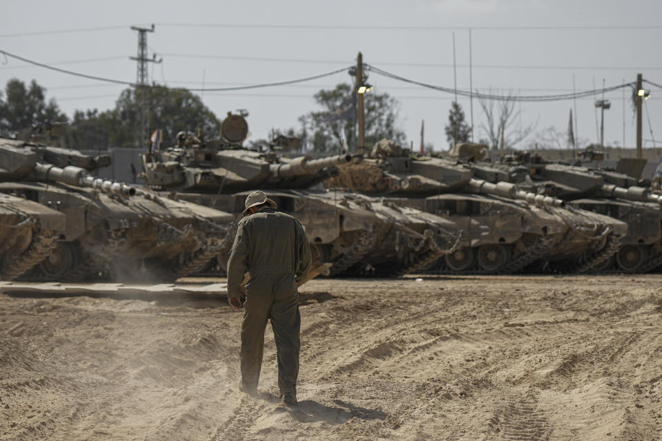 Israeli soldiers work on tanks at a staging ground near the border with the Gaza Strip, in southern Israel, Thursday, April 11, 2024. (AP Photo/Tsafrir Abayov)