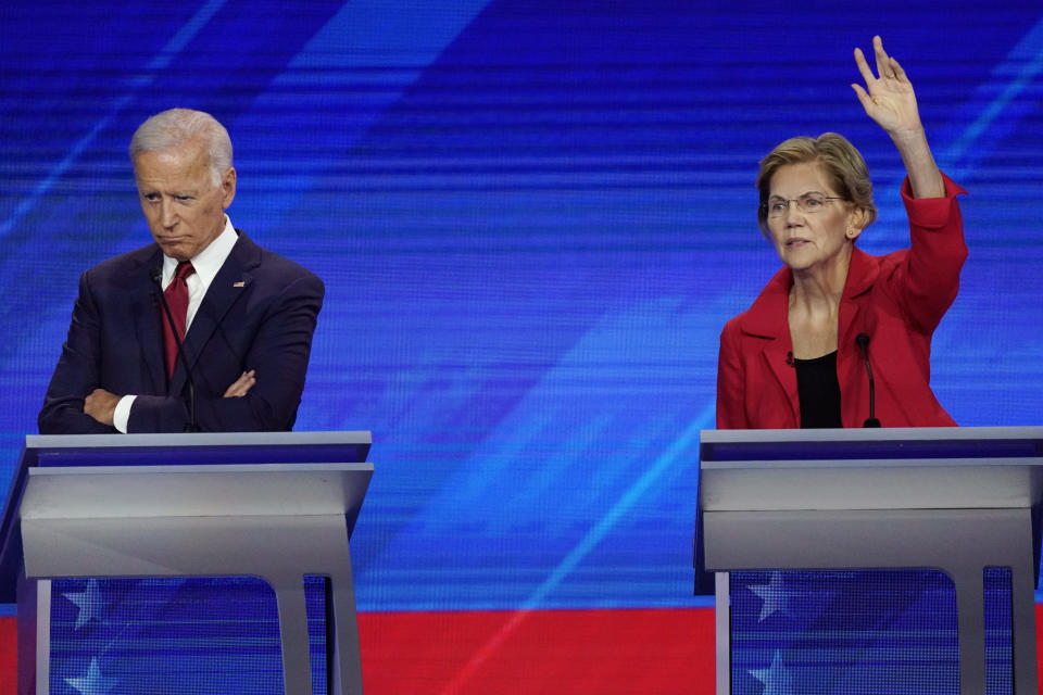 Former Vice President Joe Biden, left, and Sen. Elizabeth Warren, D-Mass., right, Thursday, Sept. 12, 2019, listen during a Democratic presidential primary debate hosted by ABC at Texas Southern University in Houston. (AP Photo/David J. Phillip)