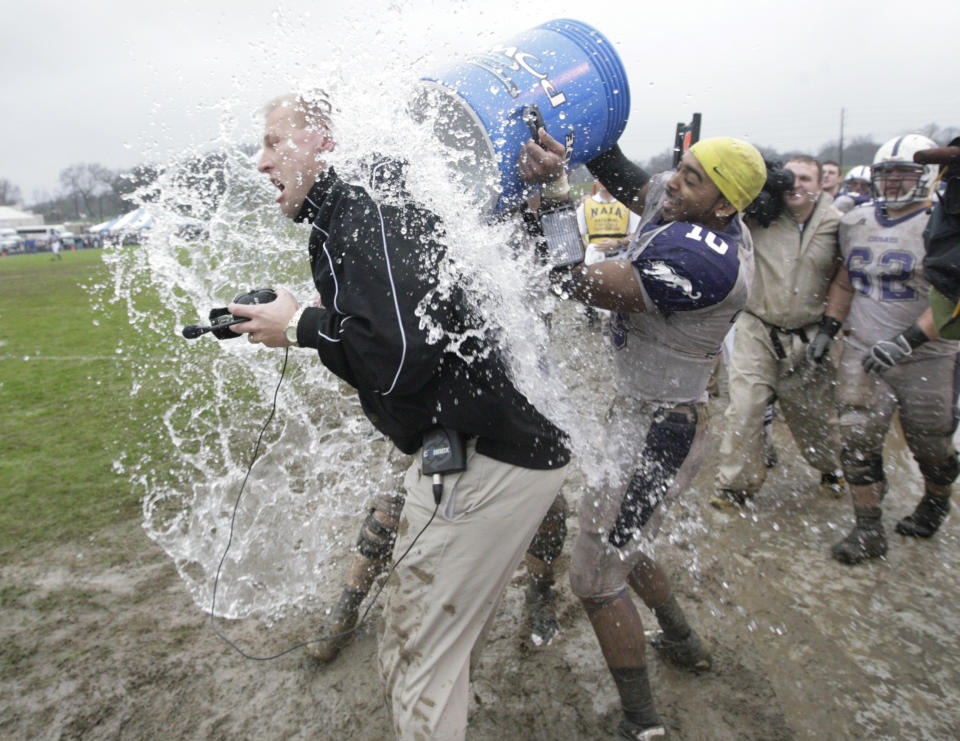 FILE - Then-Sioux Falls head coach Kalen DeBoer is dunked on the sidelines by quarterback Lorenzo Brown (10) during the closing moments of the NAIA National Championship football game against Carroll College, Saturday Dec. 20, 2008, in Rome, Ga. Sioux Falls won 23-7. Alabama is negotiating with Washington coach Kalen DeBoer and is close to hiring him as the replacement for Nick Saban, a person with direct knowledge of the talks said Friday, Jan. 12, 2024. (AP Photo/John Amis, FIle)