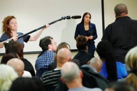 U.S. Rep. Alexandria Ocasio-Cortez (D-NY) listens to a question from an attendee during a town hall in New York