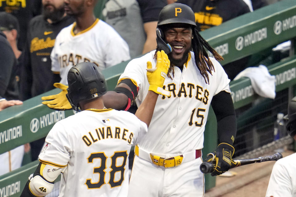 Pittsburgh Pirates' Edward Olivares (38) celebrates with Oneil Cruz (15) as he returns to the dugout after hitting a grand slam off Los Angeles Angels starting pitcher Tyler Anderson during the third inning of a baseball game in Pittsburgh, Monday, May 6, 2024. (AP Photo/Gene J. Puskar)