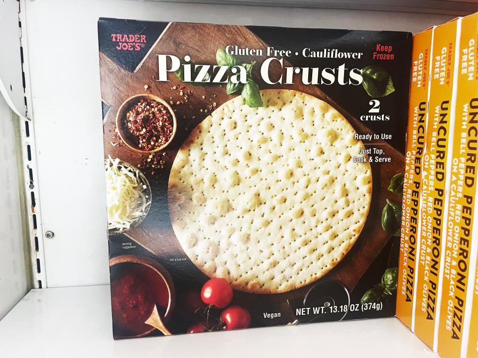 A box of gluten-free pizza crusts with images of crusts and pizza ingredients including basil and tomato on the box
