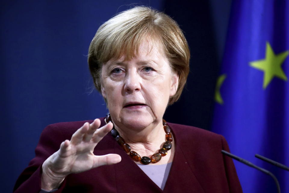 German Chancellor Angela Merkel holds a joint news conference with Finance Minister Olaf Scholz after a virtual G20 summit meeting, at the Chancellery in Berlin, Germany, Sunday Nov. 22, 2020. (Hannibal Hanschke/Pool via AP)