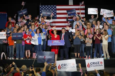 Republican U.S. presidential candidate Ted Cruz waves with Carly Fiorina after he announced Fiorina as his running mate at a campaign rally in Indianapolis, Indiana, United States April 27, 2016. REUTERS/Aaron P. Bernstein