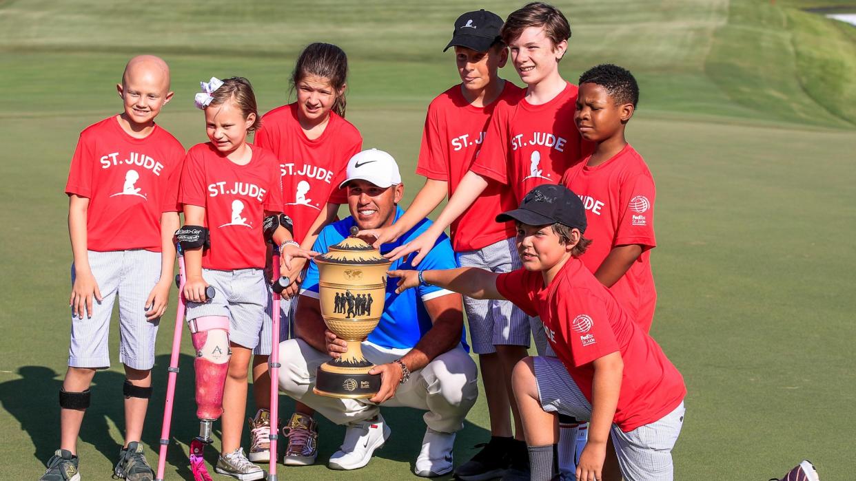 Mandatory Credit: Photo by TANNEN MAURY/EPA-EFE/Shutterstock (10349131z)Brooks Koepka of the US (C) poses with children from St.