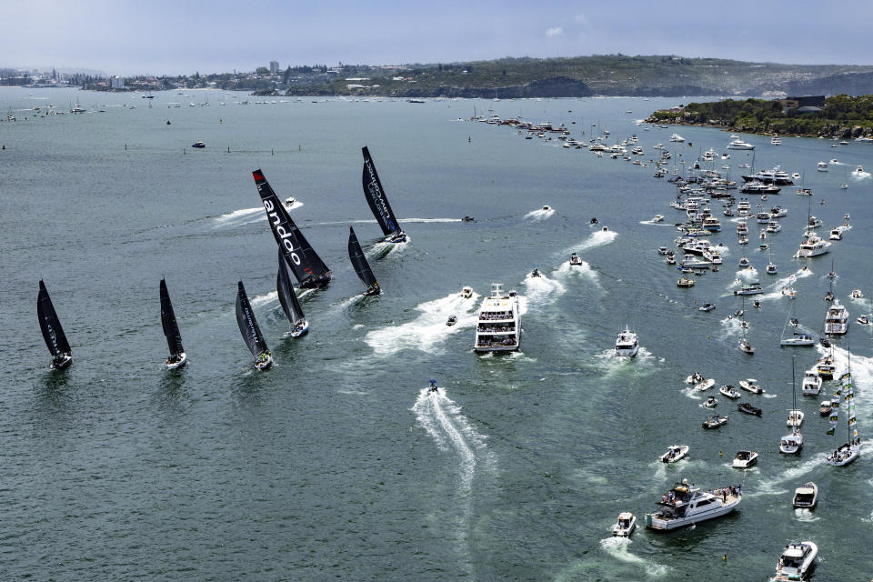 Competitors race past spectator boasts as they begin the Sydney Hobart yacht race in Sydney, Tuesday, Dec. 26, 2023. The 630-nautical mile race has more than 100 yachts starting in the race to the island state of Tasmania. (Andrea Francolini/Rolex/CYCA via AP)